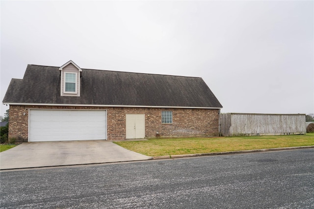 view of front of home featuring a garage and a front lawn