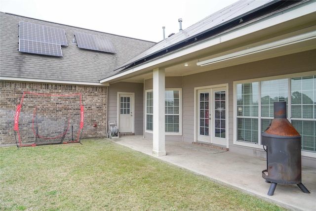 exterior space featuring a yard, a patio, and solar panels