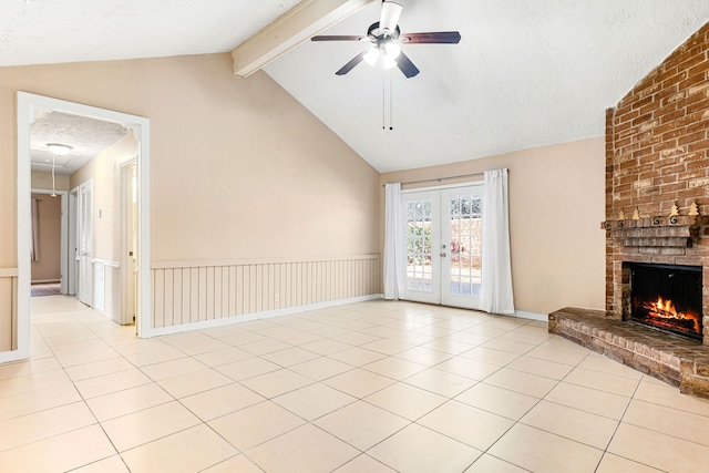 unfurnished living room featuring a fireplace, lofted ceiling with beams, a textured ceiling, and light tile patterned floors