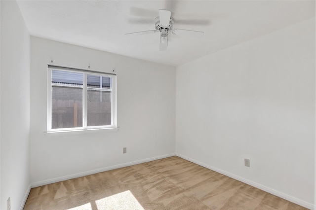 unfurnished room featuring light carpet and ceiling fan