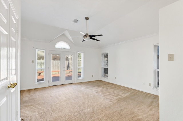 unfurnished living room featuring lofted ceiling, crown molding, ceiling fan, light carpet, and french doors