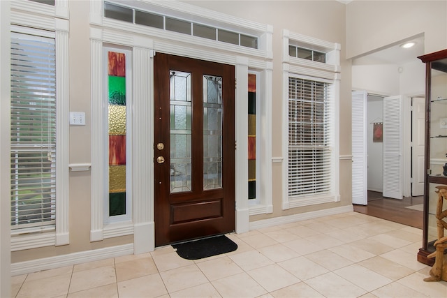 tiled foyer entrance featuring baseboards