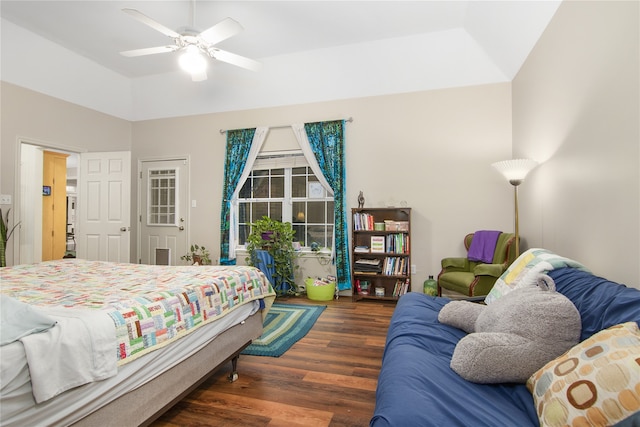 bedroom with a ceiling fan, vaulted ceiling, and wood finished floors