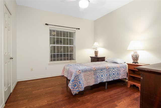 bedroom featuring ceiling fan, baseboards, and wood finished floors