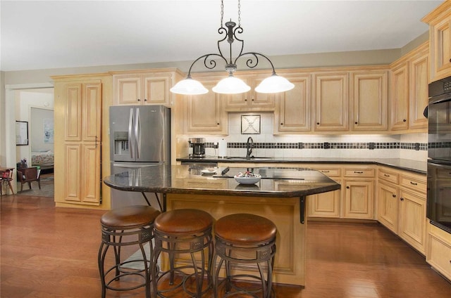 kitchen with light brown cabinets, dark wood finished floors, a sink, and stainless steel fridge with ice dispenser