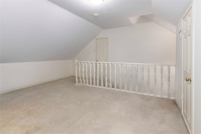 additional living space with vaulted ceiling and carpet flooring