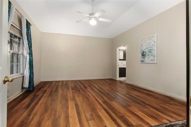 interior space featuring lofted ceiling, wood finished floors, baseboards, and ceiling fan