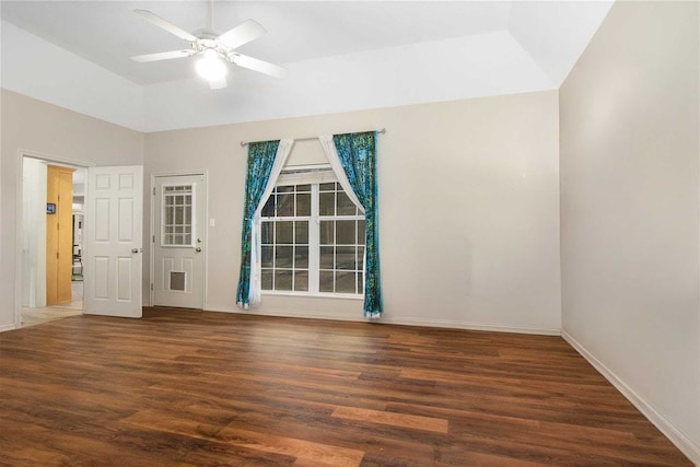 spare room with baseboards, lofted ceiling, wood finished floors, and a ceiling fan