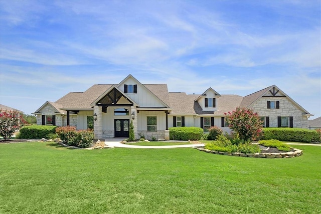 view of front facade with a front yard and french doors