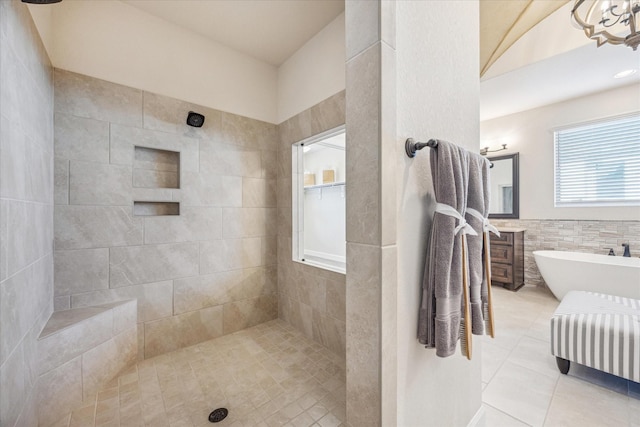 bathroom with vanity, separate shower and tub, tile patterned flooring, and tile walls