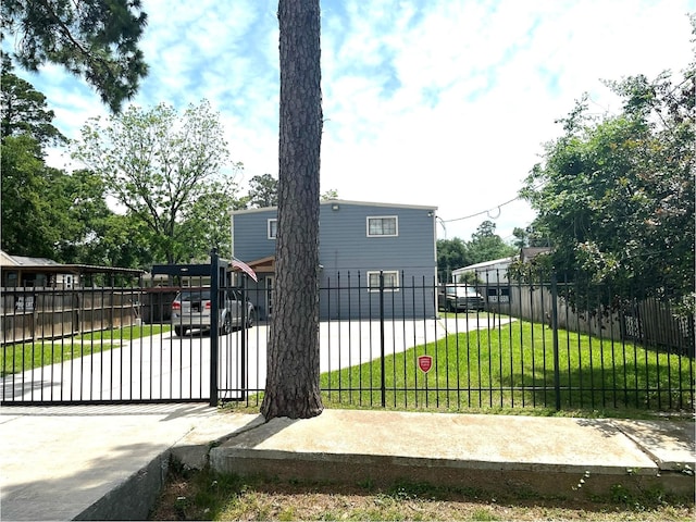 view of gate with a yard