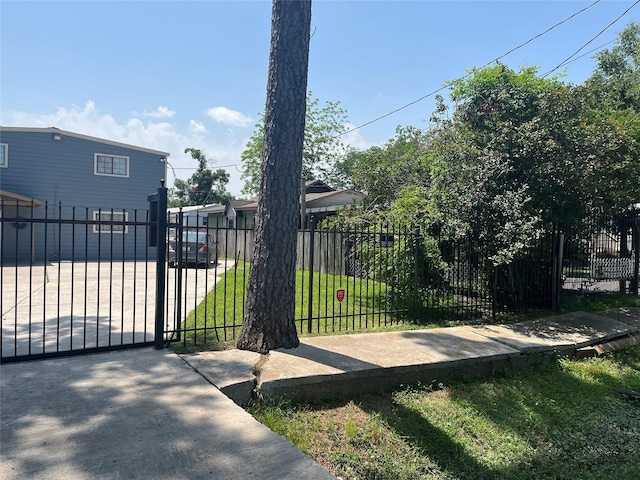 view of gate featuring a yard