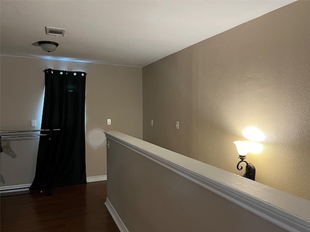 corridor featuring dark wood-type flooring