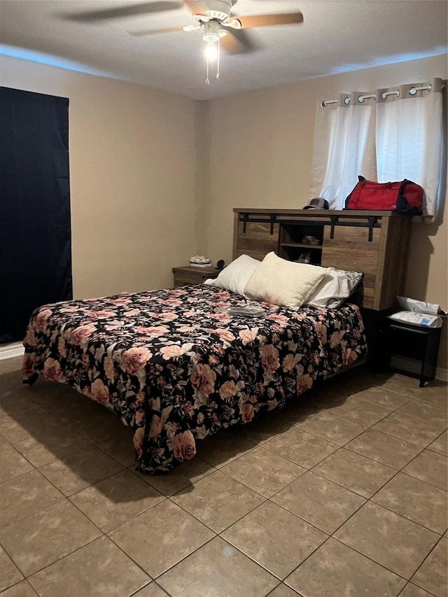 tiled bedroom with ceiling fan