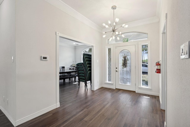 entryway featuring ornamental molding, an inviting chandelier, and dark hardwood / wood-style flooring