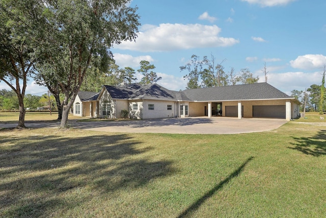 ranch-style house featuring a garage and a front lawn