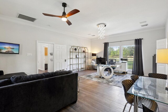 living room with hardwood / wood-style flooring, ceiling fan, and ornamental molding