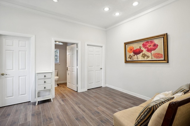 living area with ornamental molding and hardwood / wood-style floors