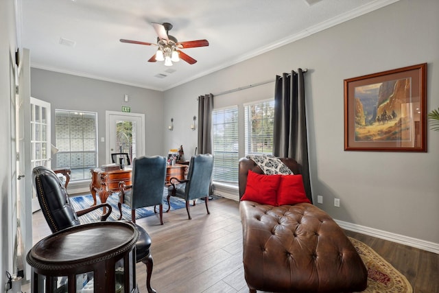 dining room with crown molding, ceiling fan, and wood-type flooring