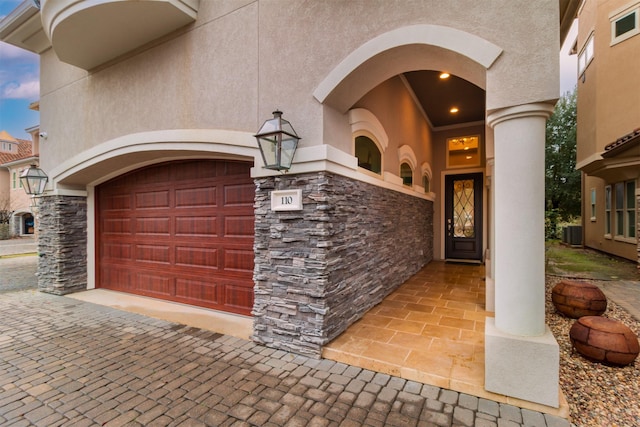 garage with decorative driveway