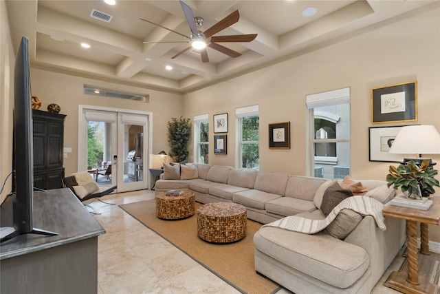 living room featuring a wealth of natural light, french doors, coffered ceiling, and a towering ceiling