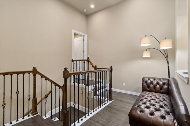 living area featuring recessed lighting, baseboards, an upstairs landing, and wood finished floors