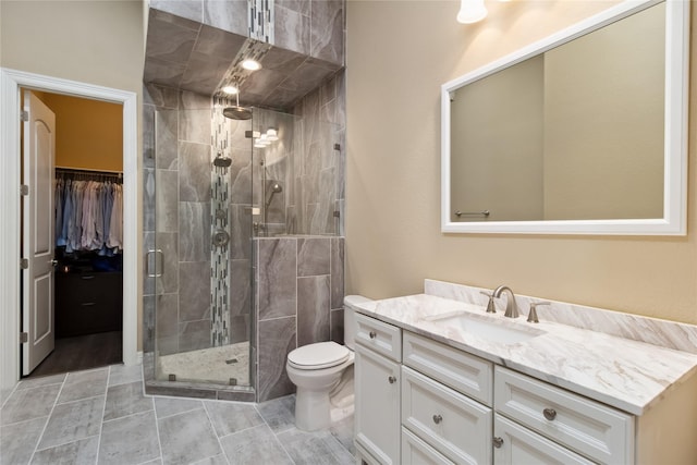 full bath with toilet, a stall shower, and vanity