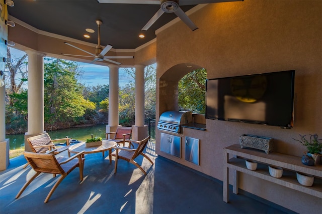 view of patio featuring grilling area, an outdoor kitchen, and a ceiling fan