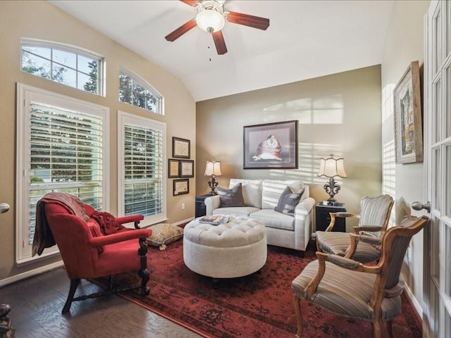 living room featuring ceiling fan, dark hardwood / wood-style floors, and vaulted ceiling