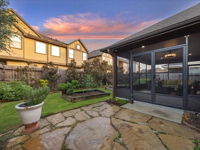 patio terrace at dusk with a sunroom