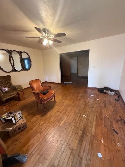 unfurnished living room with wood-type flooring and ceiling fan