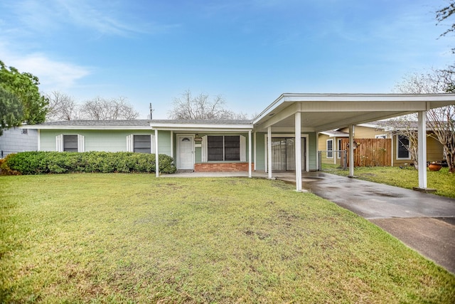 view of front of property with a carport and a front lawn