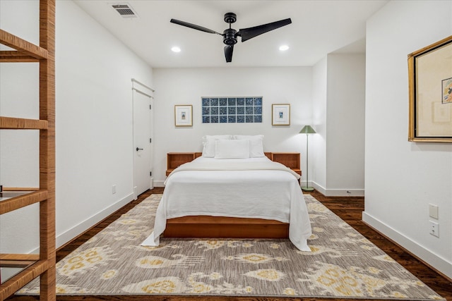 bedroom with dark hardwood / wood-style flooring and ceiling fan