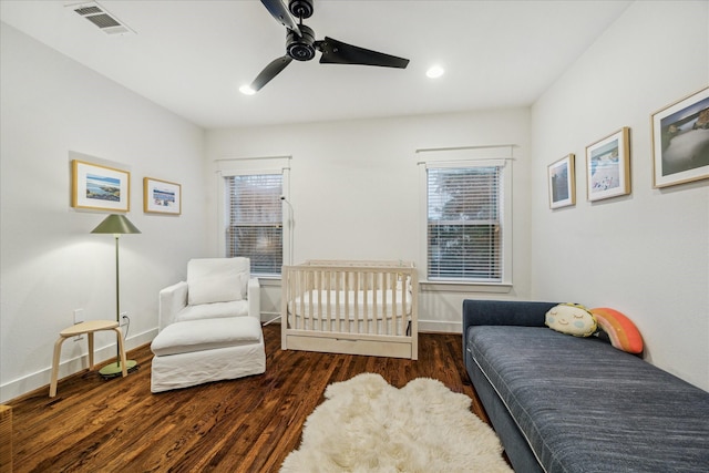 bedroom with dark hardwood / wood-style flooring and ceiling fan