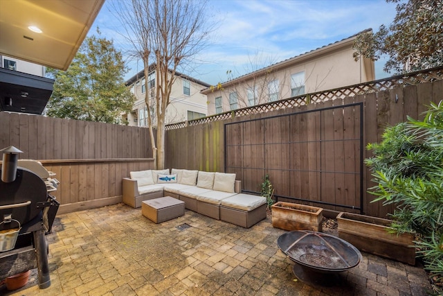 view of patio / terrace featuring area for grilling and an outdoor living space with a fire pit