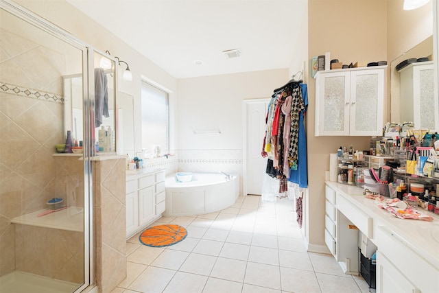 bathroom featuring vanity, shower with separate bathtub, and tile patterned flooring