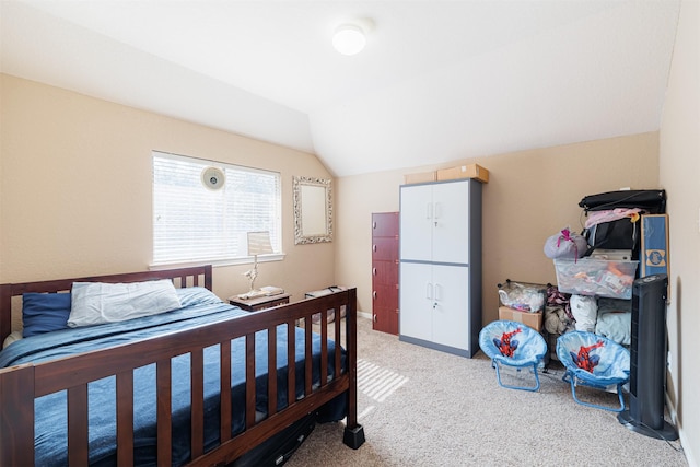 carpeted bedroom with vaulted ceiling