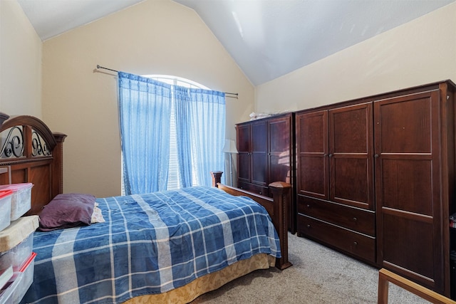 bedroom with vaulted ceiling and light colored carpet