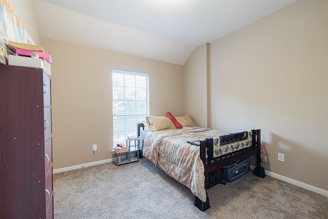 carpeted bedroom featuring lofted ceiling