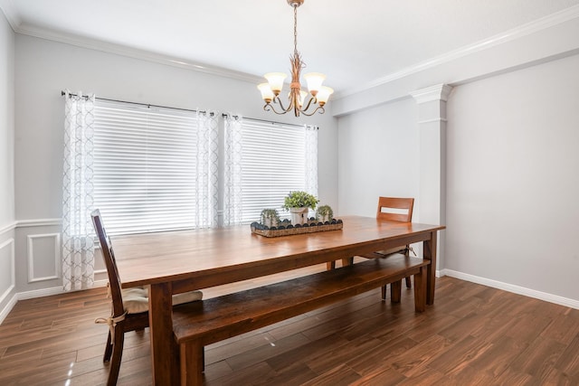 dining space with crown molding, dark hardwood / wood-style floors, and a chandelier