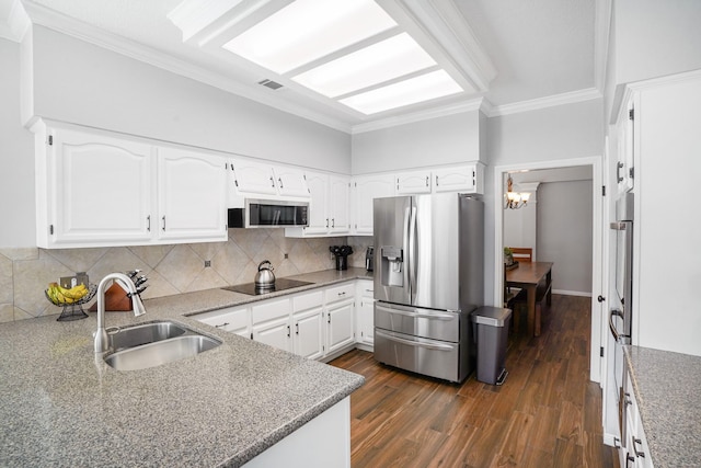 kitchen featuring white cabinetry, appliances with stainless steel finishes, crown molding, and sink