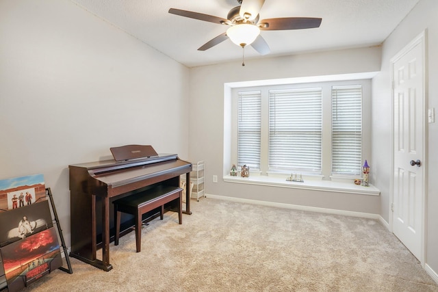 miscellaneous room featuring light colored carpet and ceiling fan