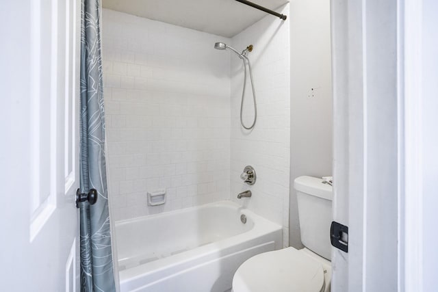 bathroom with shower / tub combo and toilet