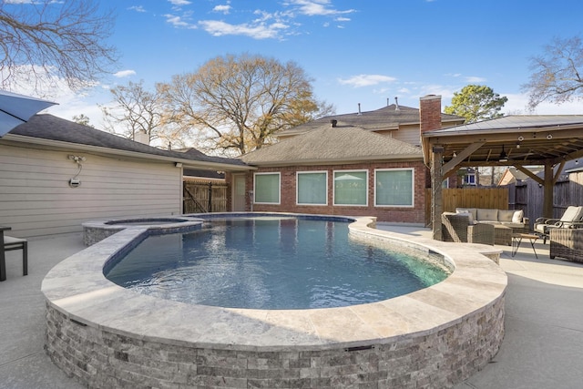 view of swimming pool featuring an in ground hot tub, a gazebo, outdoor lounge area, and a patio area