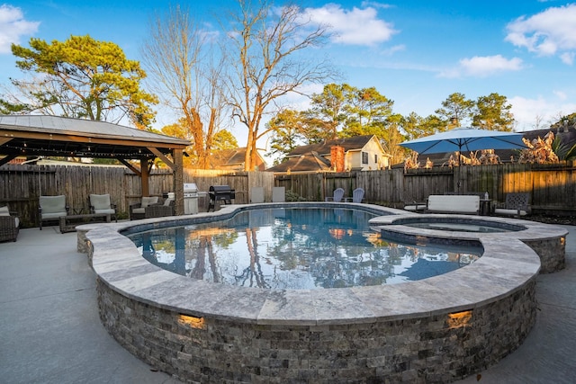 view of swimming pool with a gazebo, grilling area, an in ground hot tub, and a patio area