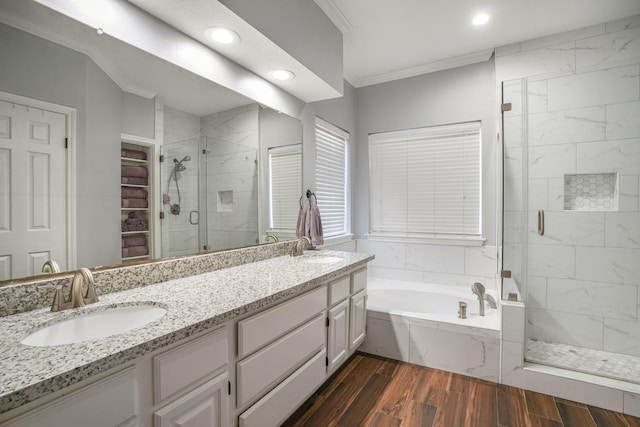 bathroom featuring hardwood / wood-style flooring, vanity, shower with separate bathtub, and crown molding