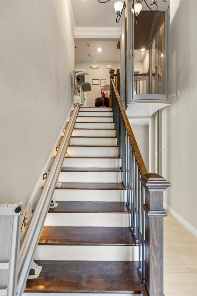 staircase featuring crown molding