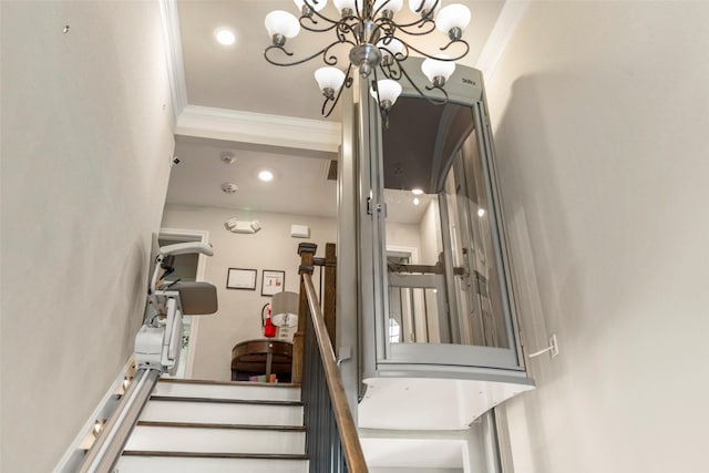 stairs featuring an inviting chandelier and ornamental molding