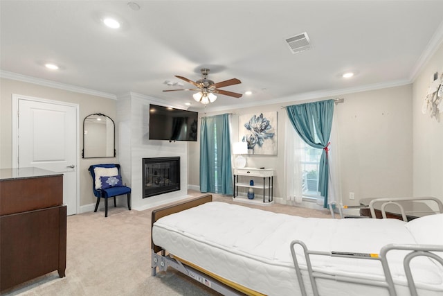 bedroom featuring ceiling fan, ornamental molding, a fireplace, and light carpet