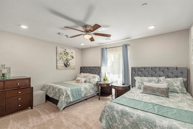 bedroom featuring light carpet and ceiling fan